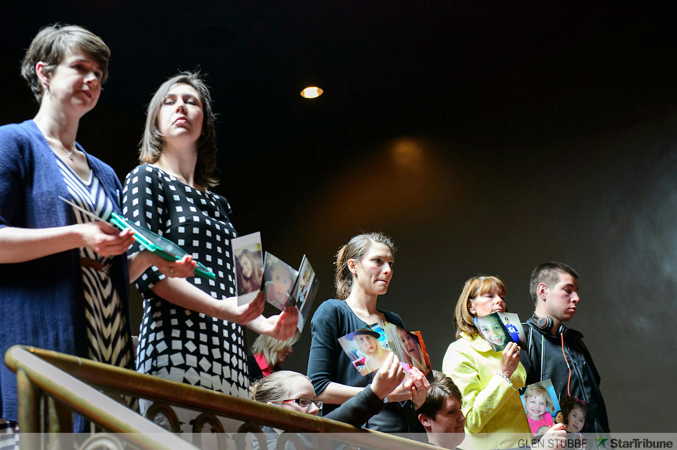 Advocates for Medical marijuana held photos of relatives, loved ones and members of families who couldn't attend the hearing as the bill was debated on the Senate floor.  L to R are Jessica Hauser, Kendra Miller, Cassie Traun, Angela Garin, Martha Schulz, Kim Kelsey and her son Alec.      ]      Tuesday, May 6, 2014   GLEN STUBBE * gstubbe@startribune.com