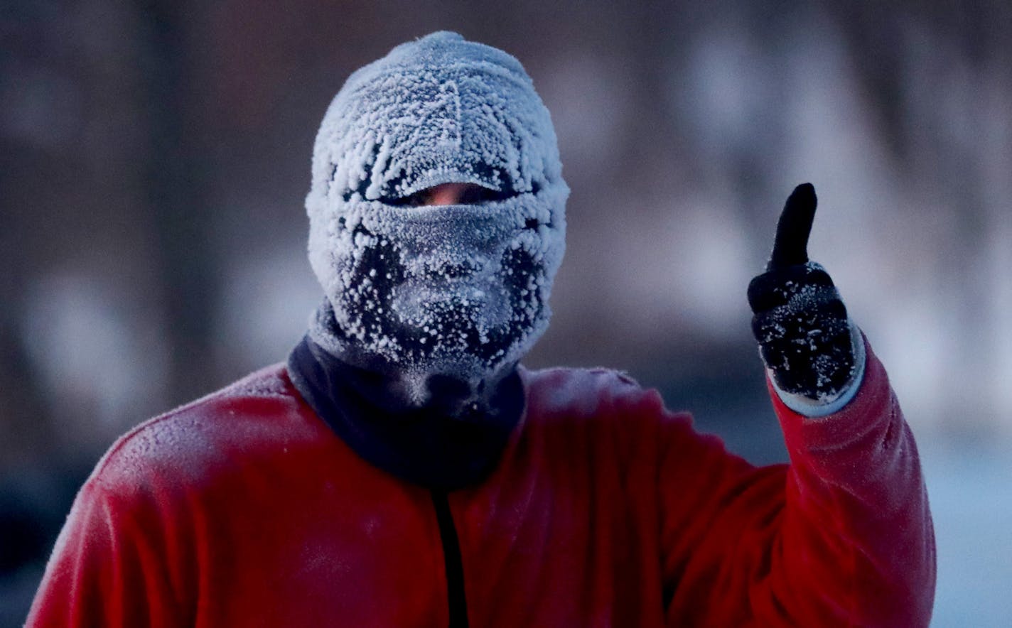 Chris, who declined to give his last name because he was concerned "people might think I'm crazy," gave a thumbs up while jogging around Lake Harriet with a head full of frost Thursday, Jan. 31, 2019, In Minneapolis, MN.