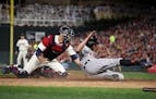 Detroit Tigers right fielder Alex Presley (14) was tagged out at home by Minnesota Twins catcher Jason Castro (21) on a throw by Minnesota Twins left 