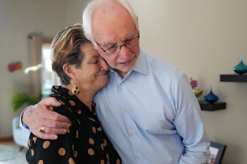 Cheryl Harms Hauser with her husband, David McNally, at their home in Hopkins.