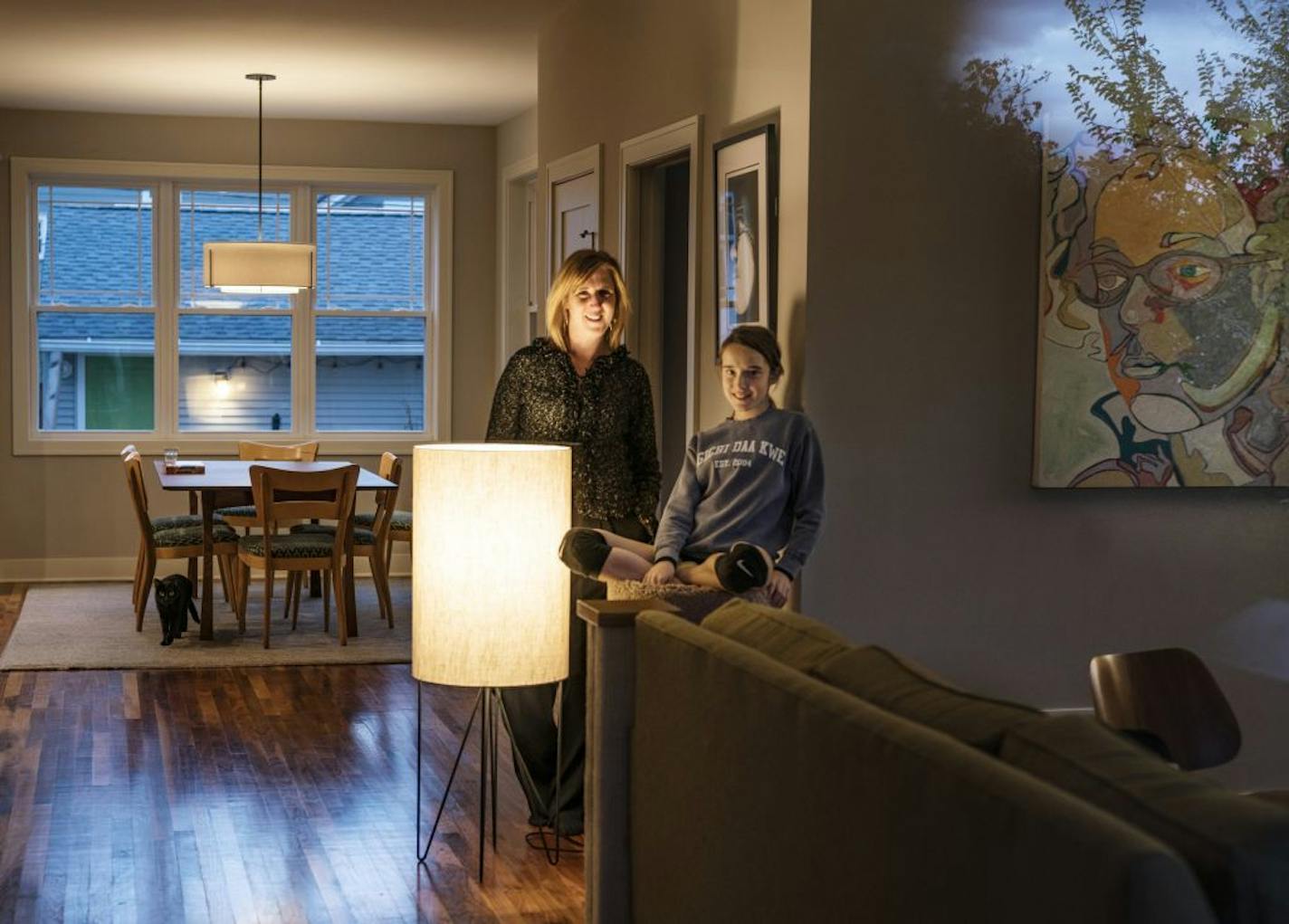 Jessica Hellmann and her daughter Ada, 11, try to avoid turning on lights in the house; those they do use have LED bulbs.