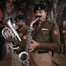 Indian soldiers practice marching tunes as they wait for the beginning of rehearsals for Republic Day parade early in the morning in New Delhi, India,