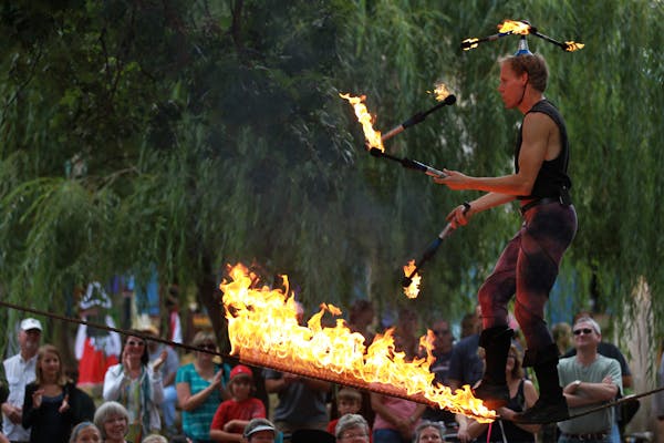 Tuey juggled as he walked a flaming rope at the Renaissance Festival in Shakopee.