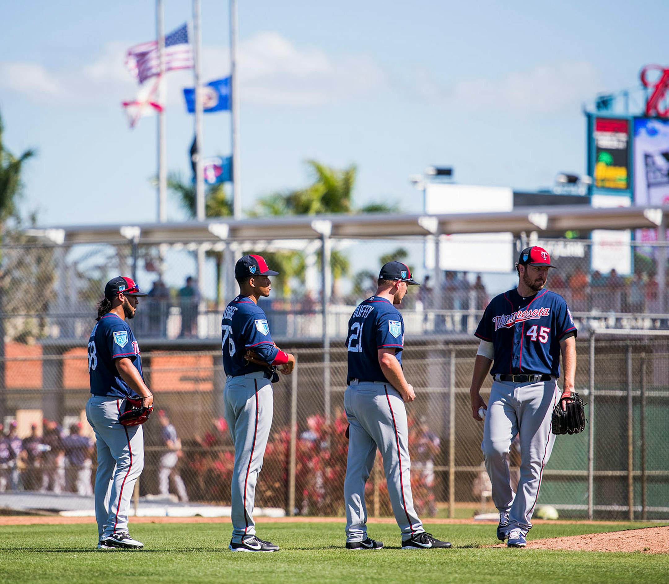Twins pitchers lined up at the mound.