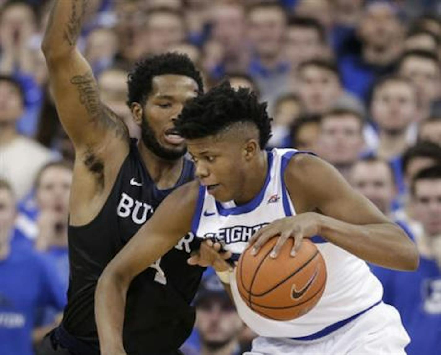 Creighton's Justin Patton, right, is defended by Butler's Tyler Wideman (4) during the first half of an NCAA college basketball game in Omaha, Neb., Wednesday, Jan. 11, 2017. (AP Photo/Nati Harnik)