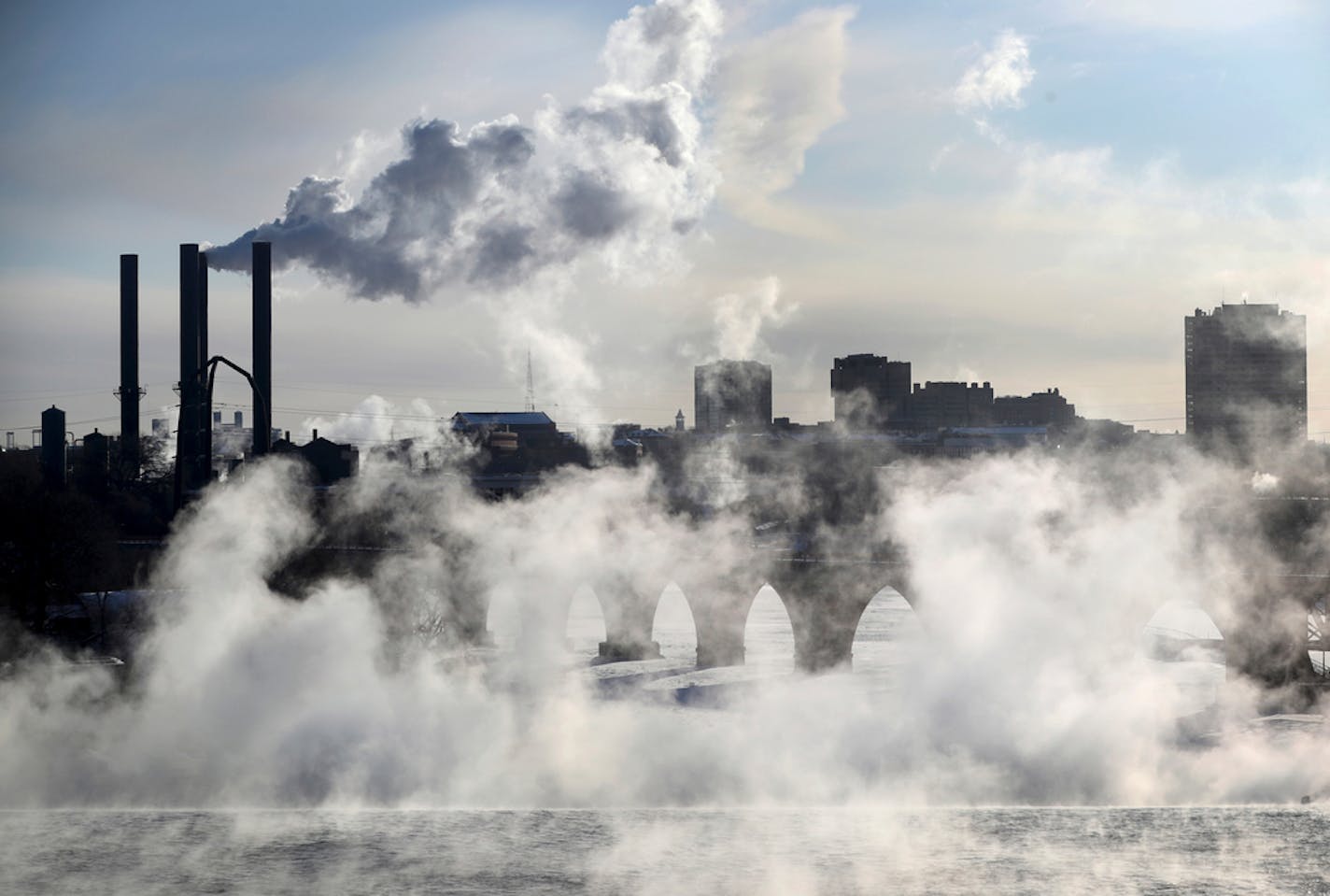 Water vapor rises above St. Anthony Falls on the Mississippi River as the Stone Arch Bridge is obscured, seen from the Third Ave. Bridge Tuesday, Jan. 29, 2019, In Minneapolis. Extreme cold and record-breaking temperatures are crawling into parts of the Midwest after a powerful snowstorm pounded the region, and forecasters warn that the frigid weather could be life-threatening. (David Joles/Star Tribune via AP)