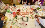 Attendees of Ann and Randy Bailey's annual cookie party decorated their cookies Saturday afternoon at the Baileys' dining room table. . ] Aaron Lavins
