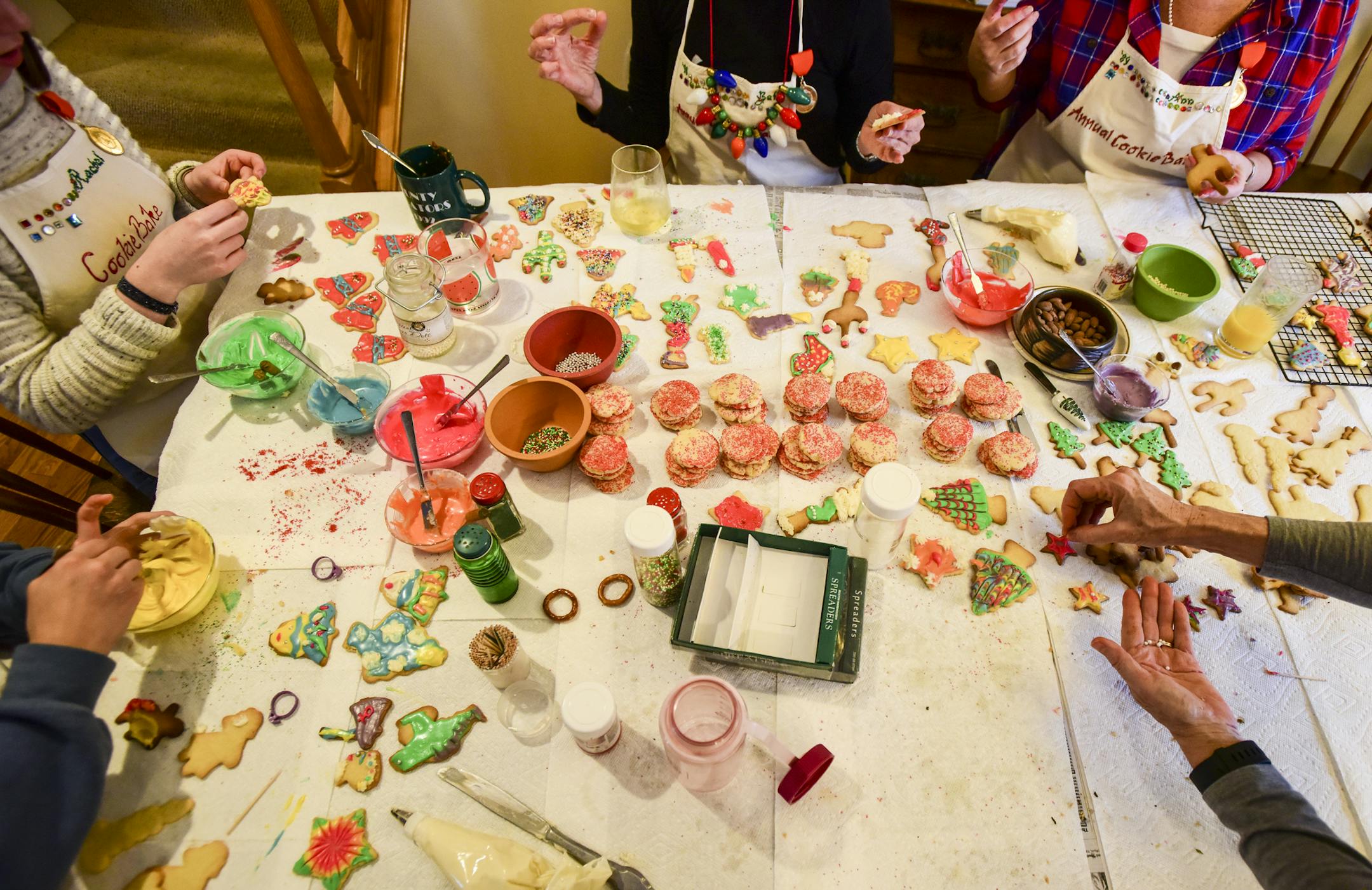 Attendees of Ann and Randy Bailey's annual cookie party decorated their cookies Saturday afternoon at the Baileys' dining room table. . ] Aaron Lavinsky • aaron.lavinsky@startribune.com Ann Bailey and her husband, Randy, hosted a group of close friends for their 30th annual cookie bake in their home in Apple Valley on Saturday, Dec. 8, 2018. Each baker has a special hand-made cookie bake apron, cross-stitched with their name. Each year, the attendees get a special 'stud' added to their ap