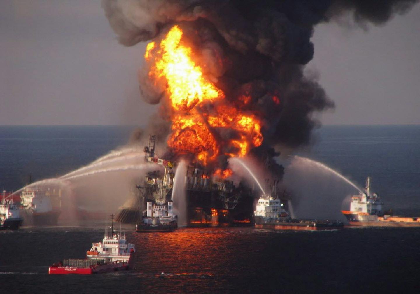 FILE - In this April 21, 2010 file photo provided by the U.S. Coast Guard, fire boat response crews spray water on the burning BP Deepwater Horizon offshore oil rig. An April 20, 2010 explosion at the platform killed 11 men, and the subsequent leak released an estimated 172 million gallons of petroleum into the gulf.