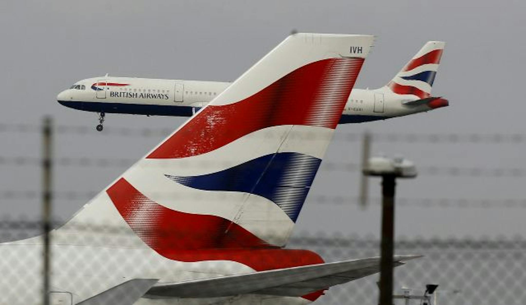 A British Airways plane comes in to land behind a tail fin at Heathrow Airport in London.