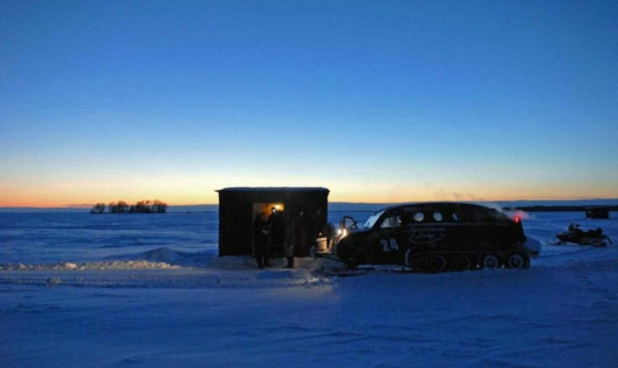 In winter on giant Lake of the Woods, ice and cold prevail. But anglers and their guides prevail. Here, at day's end, a couple of ice fisherment prepare to head back to Oak Island, on the American side of the lake about 30 miles from Baudette, Minn.