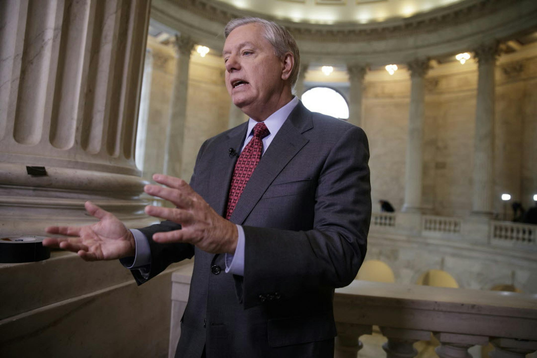 Sen. Lindsey Graham, R-S.C., a member of the Armed Services Committee and the Judiciary Committee, responds during a TV news interview to a question about President Donald Trump's administration and ousted national security adviser Michael Flynn, Wednesday, Feb. 15, 2017, on Capitol Hill in Washington. (AP Photo/J. Scott Applewhite)