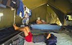 A still image from the documentary "Chasing Asylum," shows men in tents in the detention center on Nauru Island. (CinemaPlus) ORG XMIT: 1188703