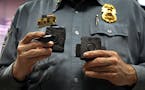 Minneapolis Police Lt. Greg Reinhardt displayed two of the body cameras that will be tested by the department. Both cameras will record 9.5 hours of v