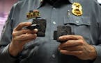Minneapolis Police Lt. Greg Reinhardt displayed two of the body cameras that will be tested by the department. Both cameras will record 9.5 hours of v