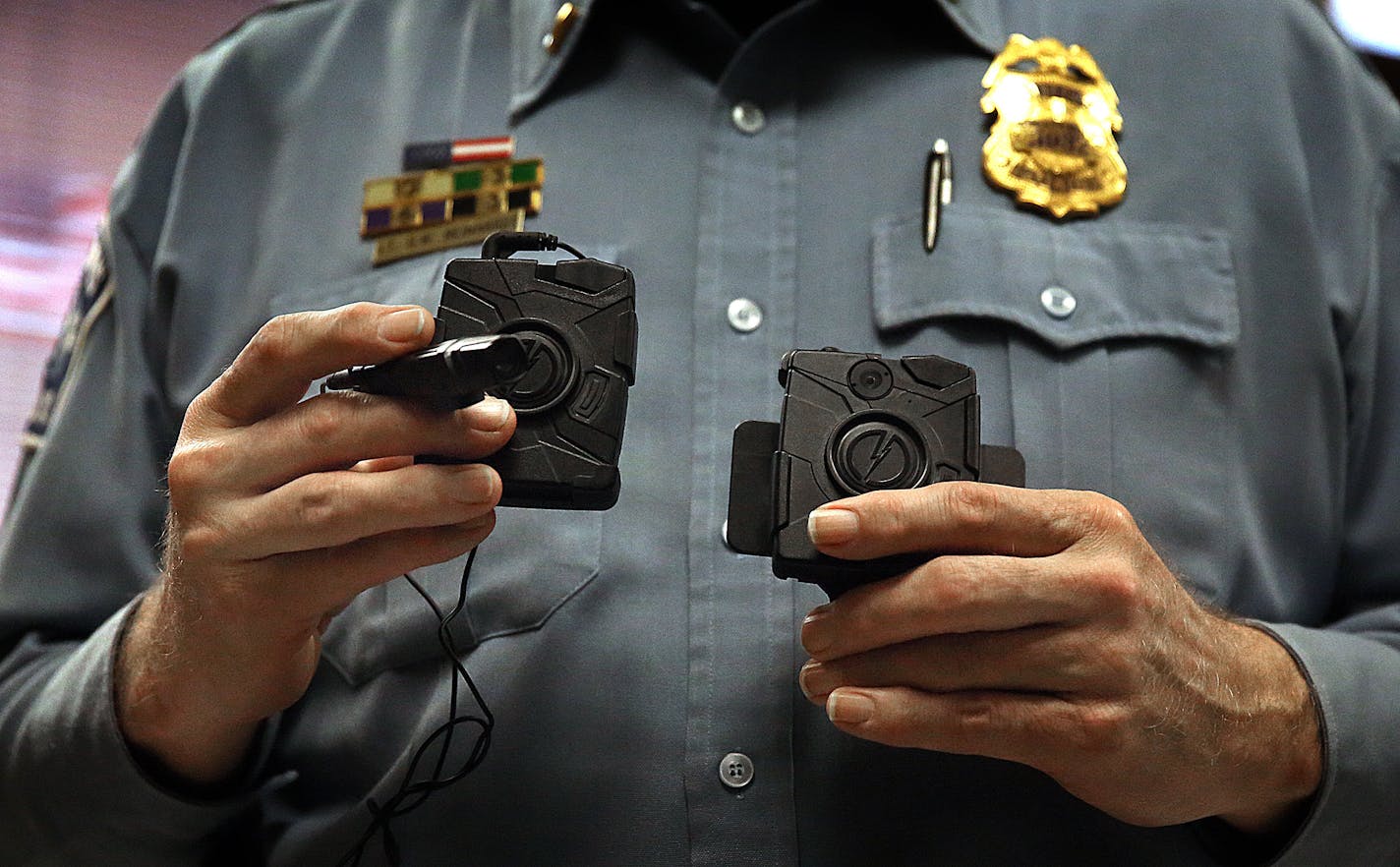 Minneapolis Police Lt. Greg Reinhardt displayed two of the body cameras that will be tested by the department. Both cameras will record 9.5 hours of video (non-HD) and are made by Taser. One camera attaches to an officer's body and is completely self-contained, while the other offers a more flexible option, with a thinner camera attached to a battery.