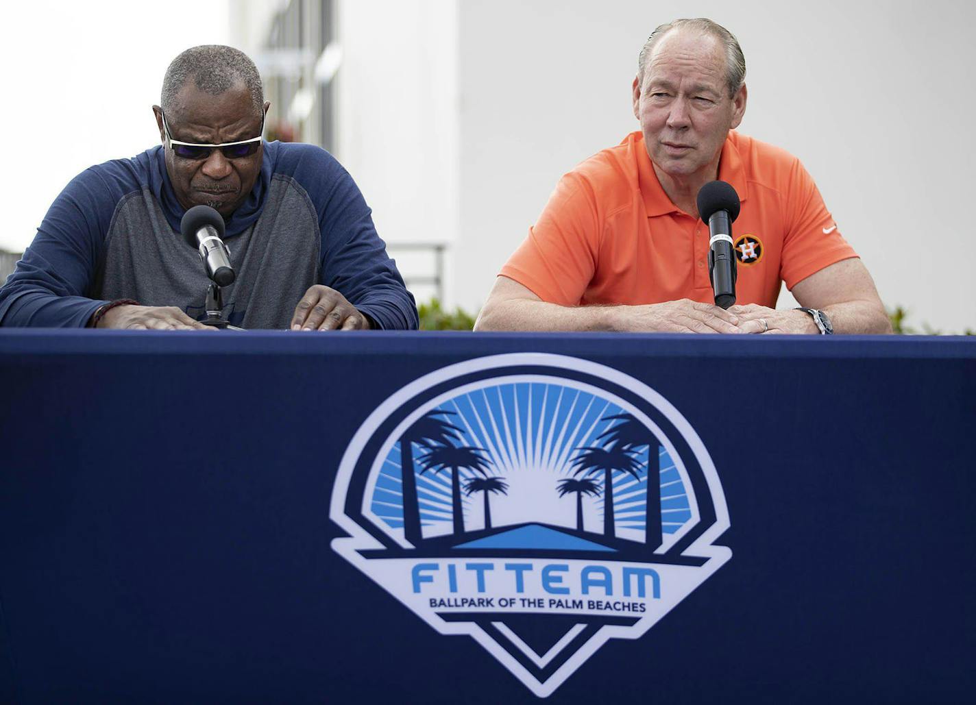 Houston Astros manager Dusty Baker, left, listens as team owner Jim Crane talks during a news conference before the start of spring training