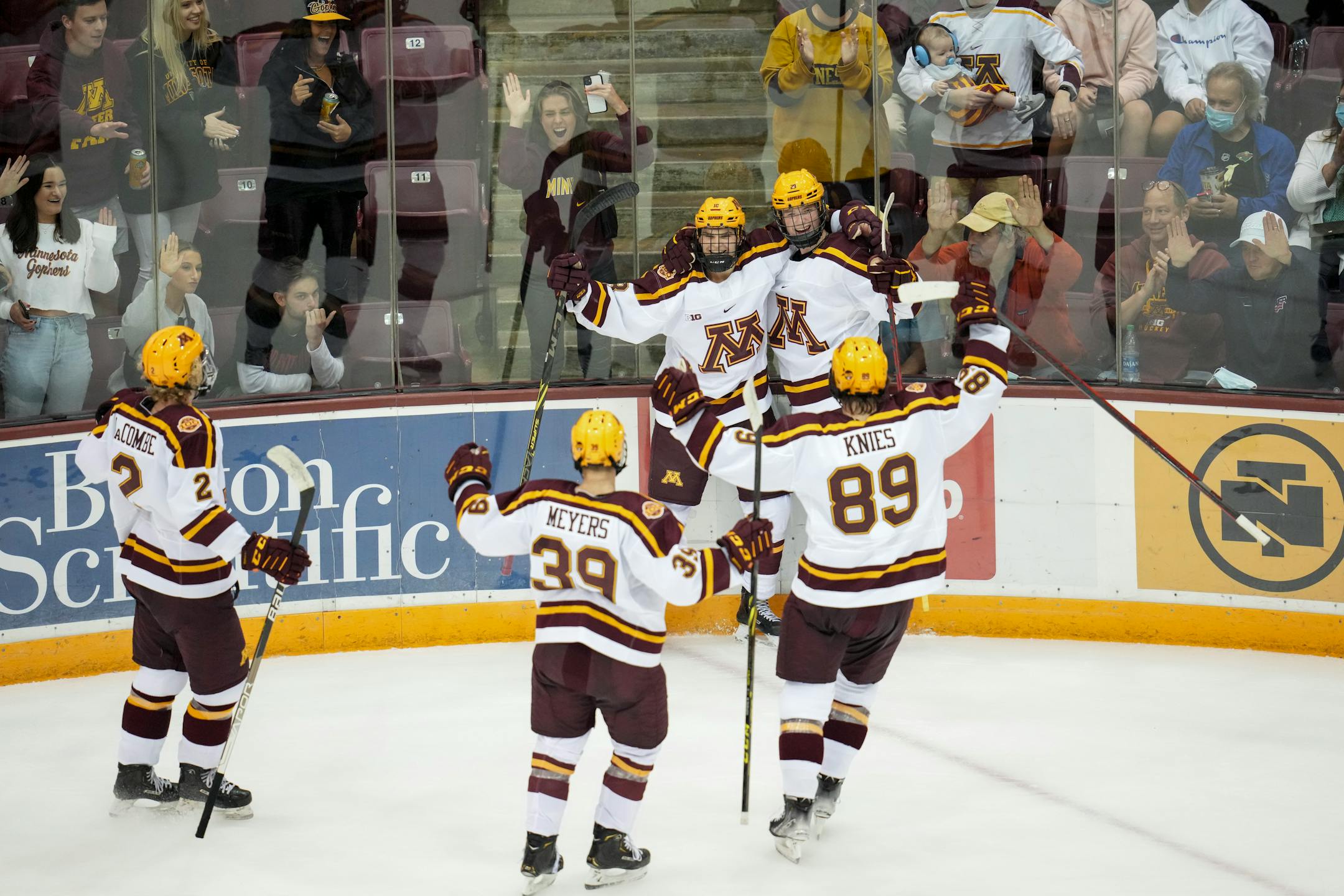 Teammates celebrated with Minnesota forward Mason Nevers (18) after he scored in the first period.