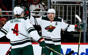 Wild left wing Marcus Foligno celebrates his goal against the Coyotes with defenseman Jon Merrill during the first period Wednesday