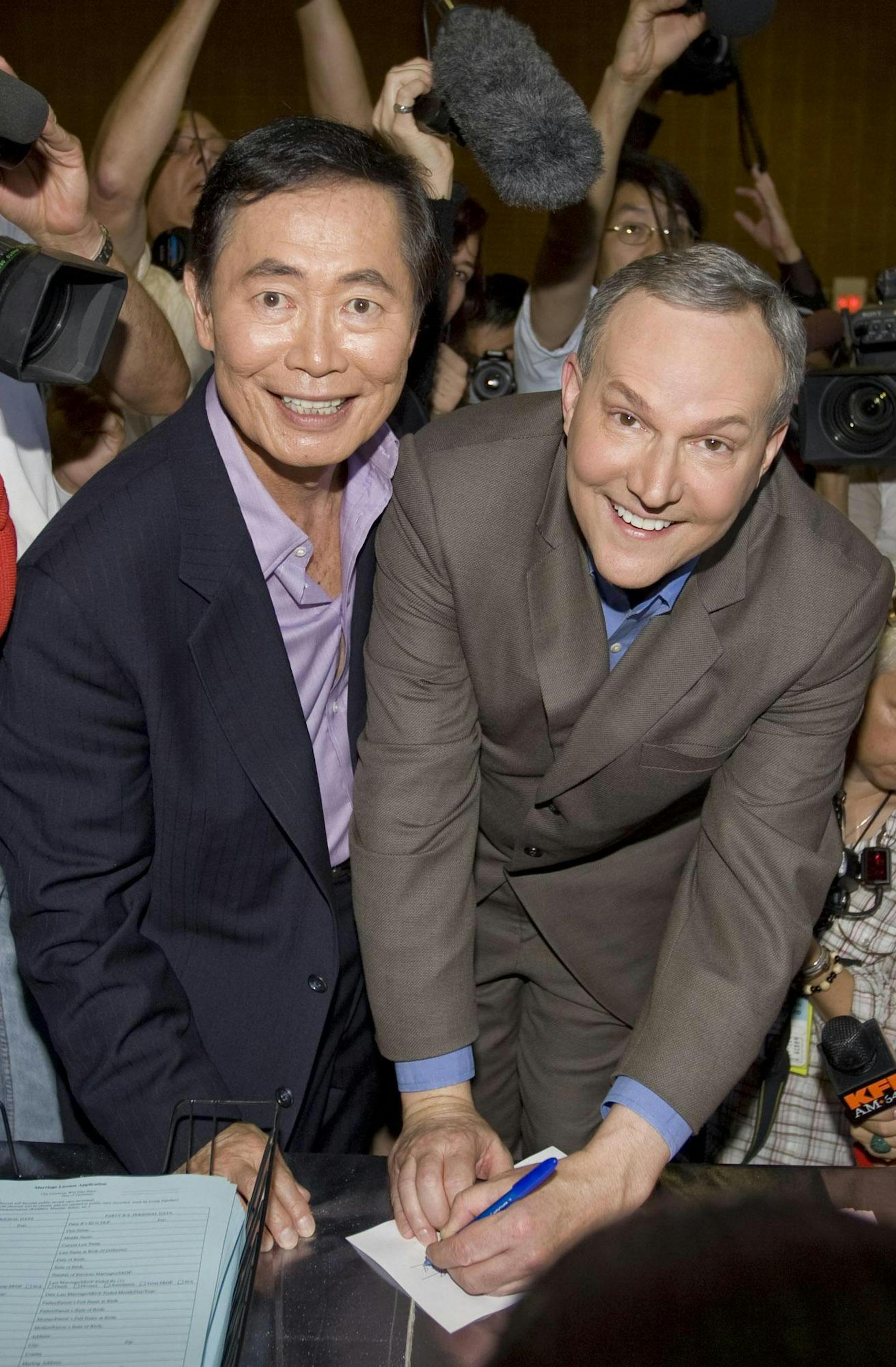 Actor George Takei, left, and his partner Brad Altman sign documents as they get their marriage certificate permit in West Hollywood, Calif., Tuesday, June 17, 2008. (AP Photo/Hector Mata) ORG XMIT: MIN2015030213232053