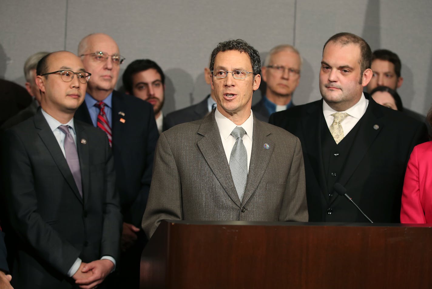 Senator Ron Latz, center, addressed the press alongside Ramsey County Attorney John Choi, left, and Representative Dan Schoen, as they introduced a new gun safety bill during a press conference at the Minnesota State Office Building, Thursday, March 10, 2016 in St. Paul.