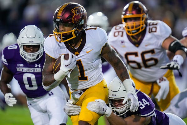 Minnesota running back Darius Taylor (1) is tackled by Northwestern linebacker Xander Mueller (34) during the first half of an NCAA college football g