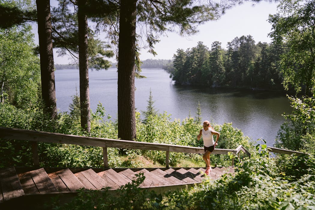 Kara Goucher, seen running at her cabin in northern Minnesota, said for her, the cliché is true: The lake is her happy place.