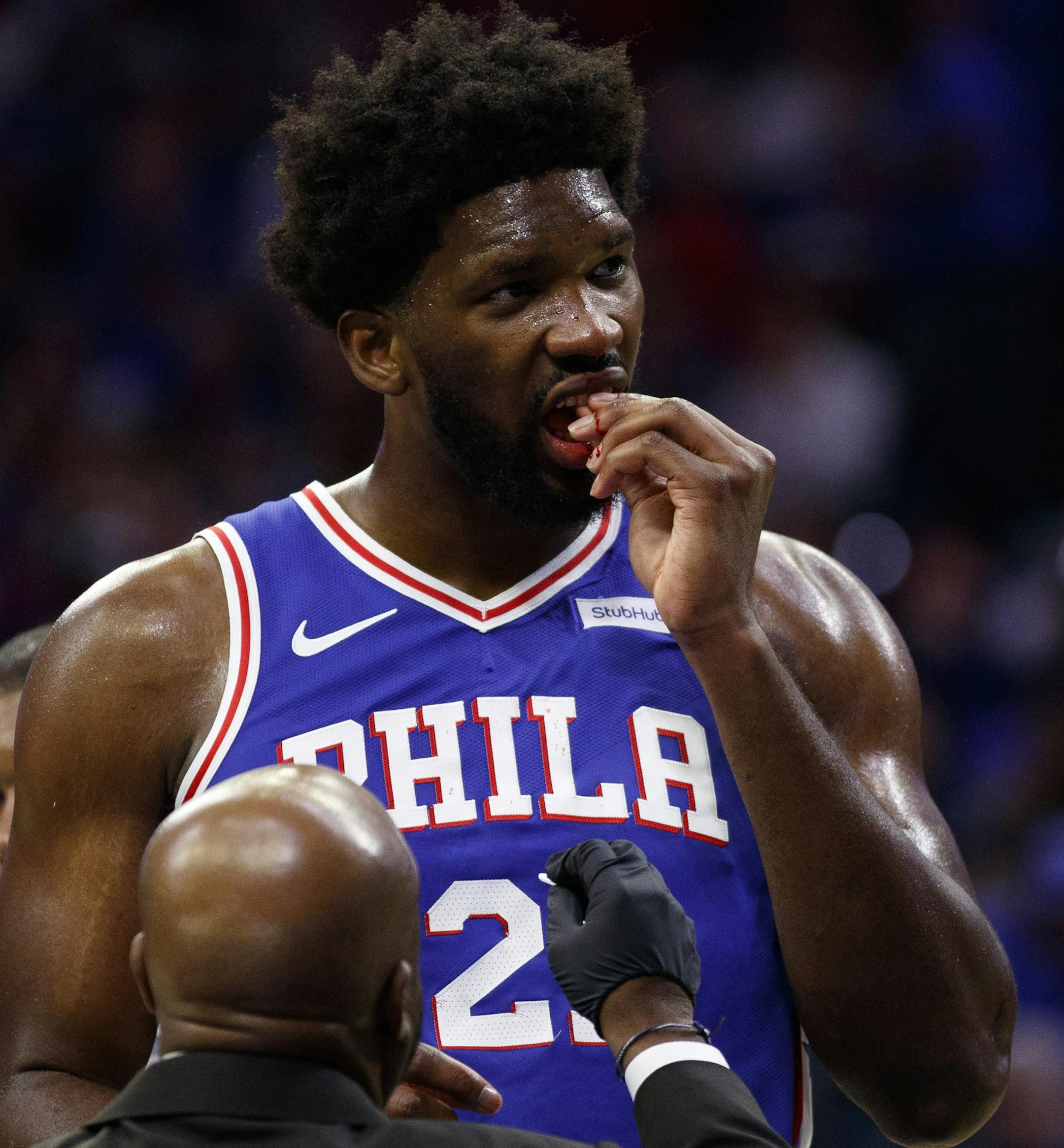 Philadelphia 76ers' Joel Embiid looks on while dealing with a bloody mouth during the second half of an NBA basketball game against the Boston Celtics, Wednesday, Oct. 23, 2019, in Philadelphia. The 76ers won 107-93. (AP Photo/Chris Szagola)