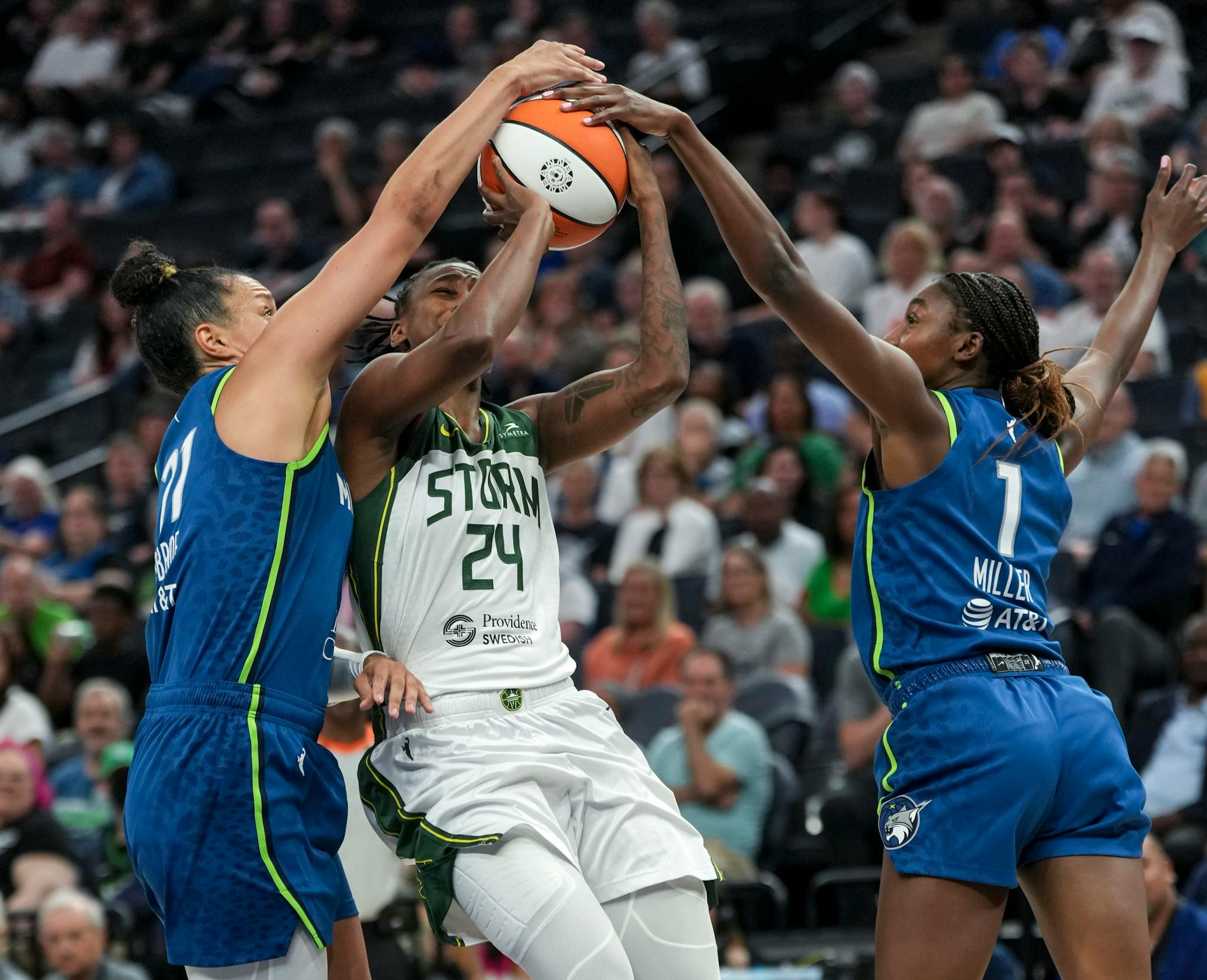 Minnesota Lynx guard Kayla McBride (21) and Minnesota Lynx guard Diamond Miller (1) knock the ball from Seattle Storm guard Jewell Loyd (24) in the first half. The Minnesota Lynx hosted the Seattle Storm on Tuesday, June 27, 2023 at the Target Center in Minneapolis.