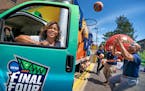 Cydni Bickerstaff, VP of event operations with the Fan Jam truck. Staff members shot baskets on the side of the truck. from left, Cordell Smith, Jack 