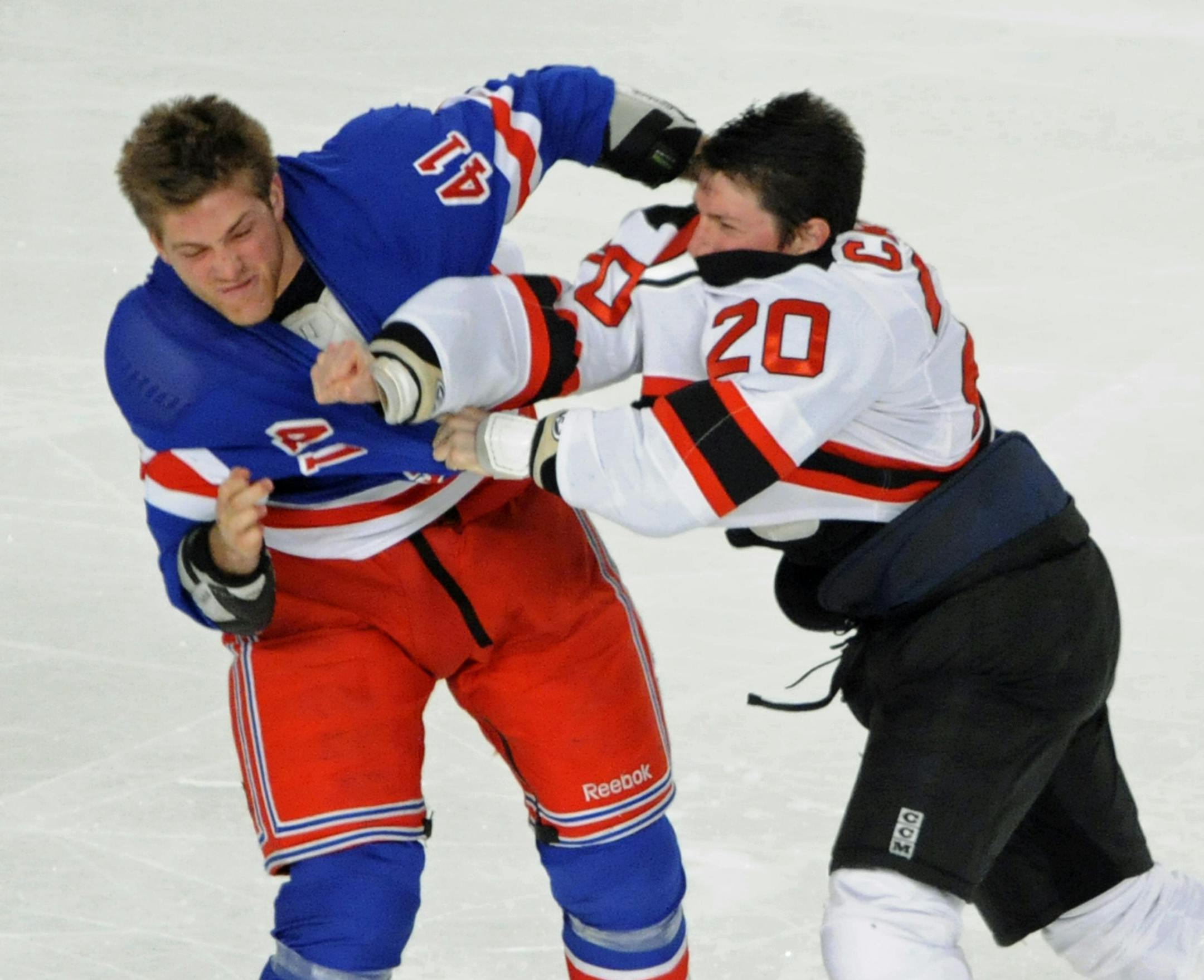 New Jersey Devils' Ryan Carter, right, fights with New York Rangers' Stu Bickel during the first period of an NHL hockey game Monday, March 19, 2012, at Madison Square Garden in New York. (AP Photo/Bill Kostroun) ORG XMIT: NYBK101