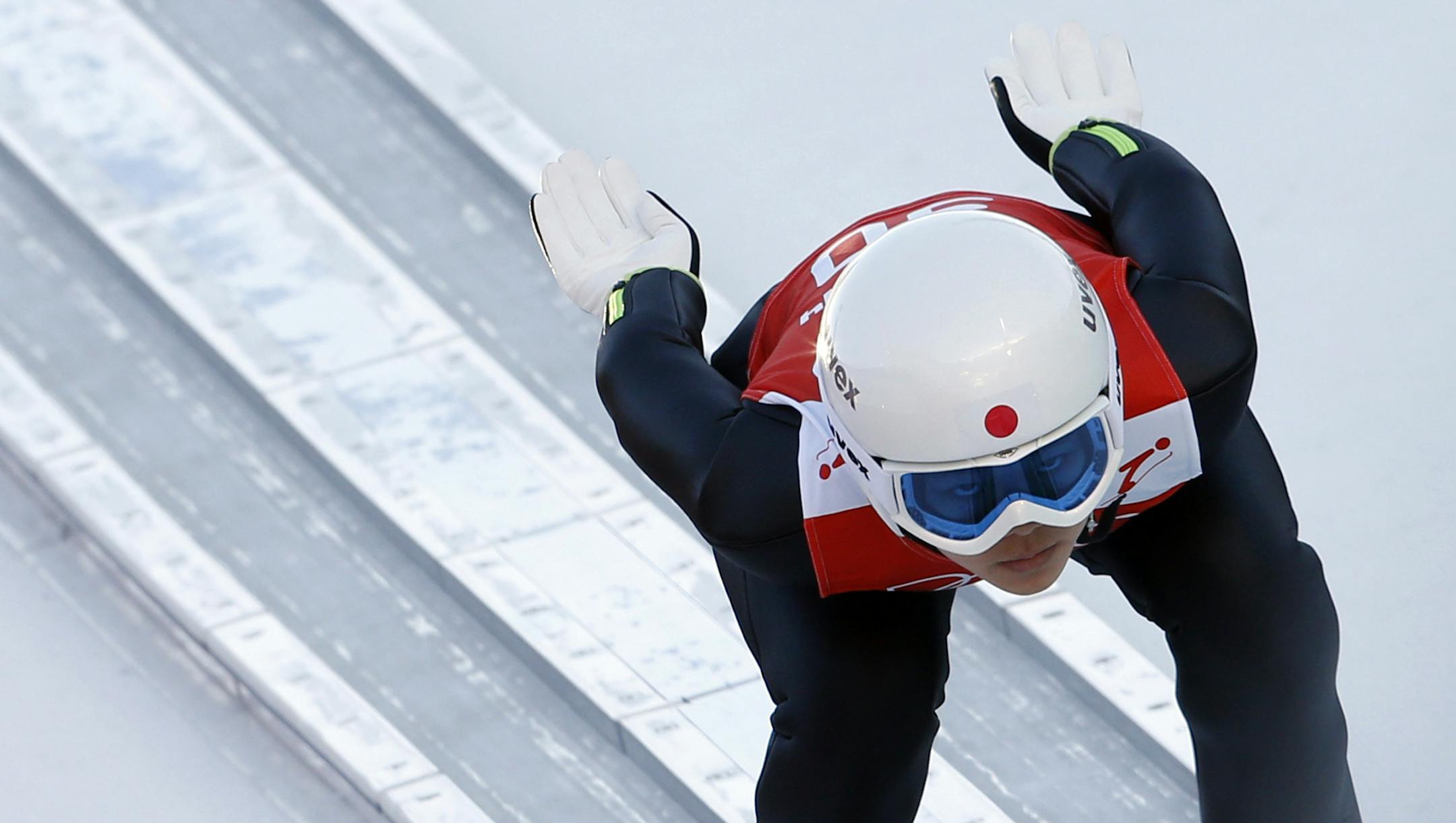 Japan's Sara Takanashi speeds down the track during a women's ski jumping training session at the 2014 Winter Olympics, Saturday, Feb. 8, 2014, in Krasnaya Polyana, Russia. (AP Photo/Matthias Schrader)
