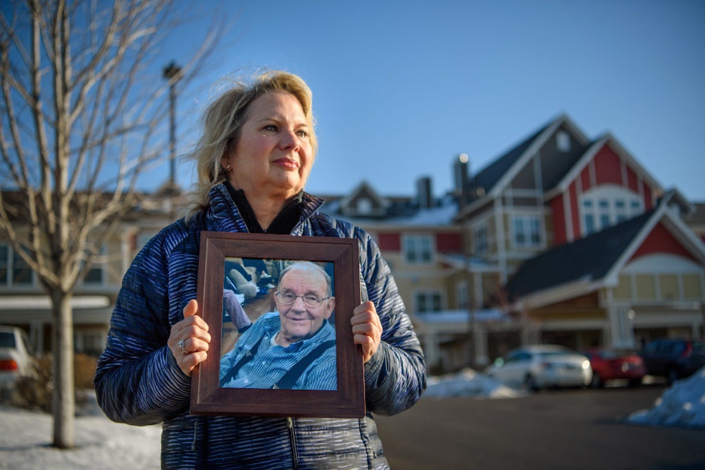 Joan Maurer holds a photograph of her late father Gerald Seeger. After he died, a senior home in Columbia Heights tried to block Maurer from suing the facility.