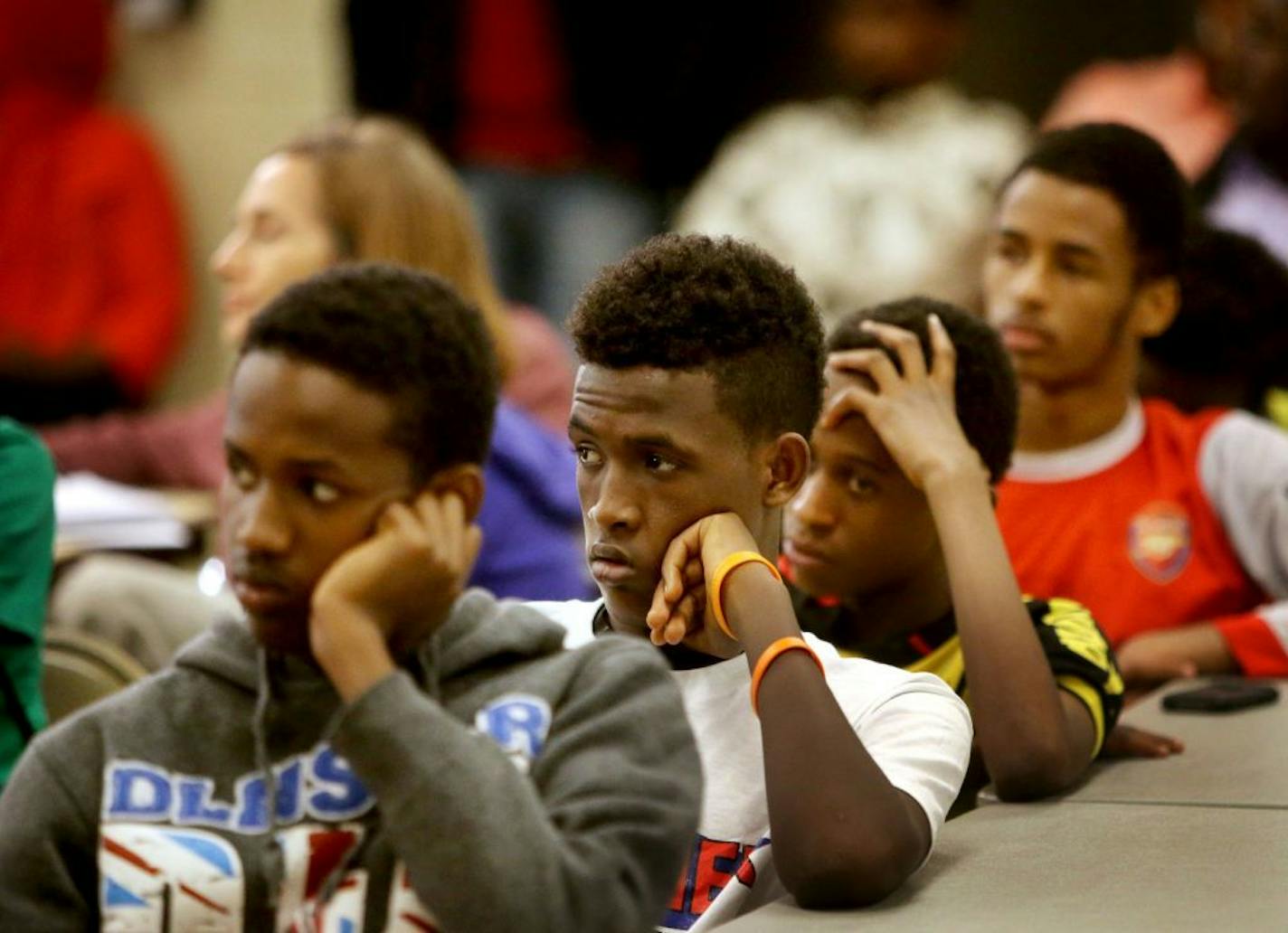 Young people, including some youth members of a Phillip's Community Center soccer team, listen to local FBI members during a town hall meeting with members of the Somali community about the recent charges against six men accused of trying to join ISIL. The town hall meeting took place at the Phillip's Community Center Saturday, May 9, 2015, in Minneapolis, MN.