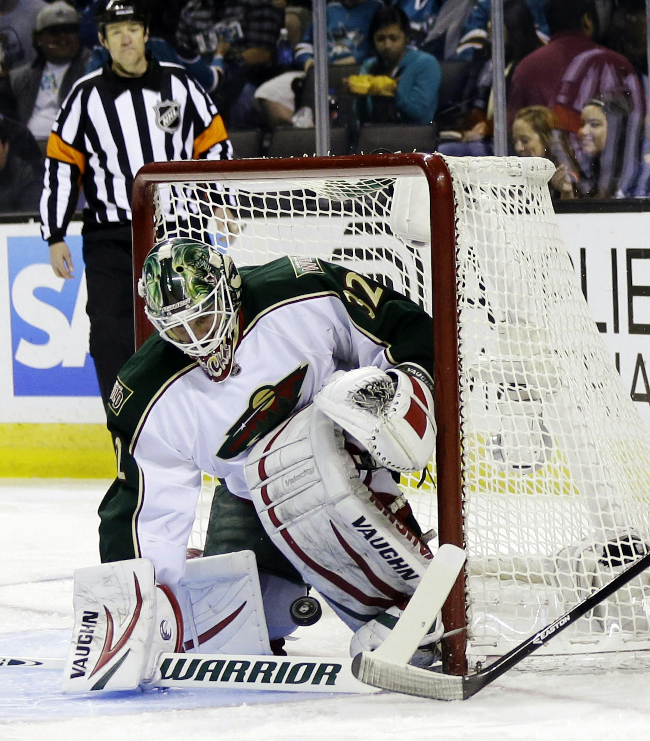 Minnesota Wild goalie Niklas Backstrom, left, of Finland, stops a shot attempt from San Jose Sharks center Logan Couture (39) as defenseman Jonas Brodin, center, watches during the first period of an NHL hockey game in San Jose, Calif., Thursday, April 18, 2013. (AP Photo/Marcio Jose Sanchez)
