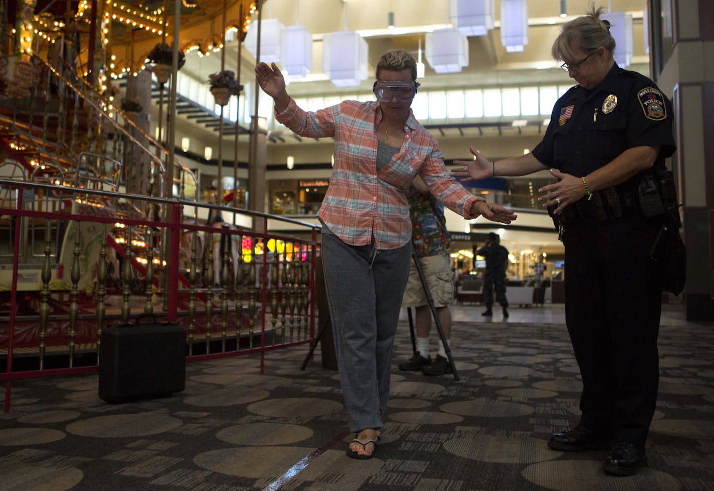 Shannon Whitman of Hugo took a field sobriety test with drunk-vision goggles with Maple Grove detective Laurel Slawson.