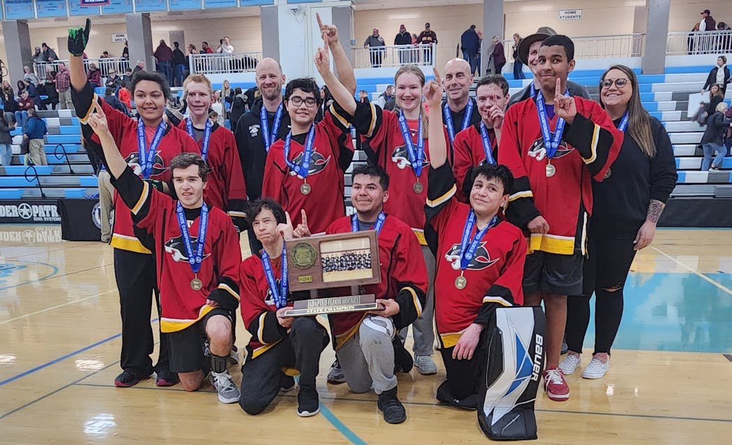 A trophy and their fingers indicated that the Blazing Cats of Burnsville/Farmington/Lakeville won an adapted floor hockey championship Saturday.