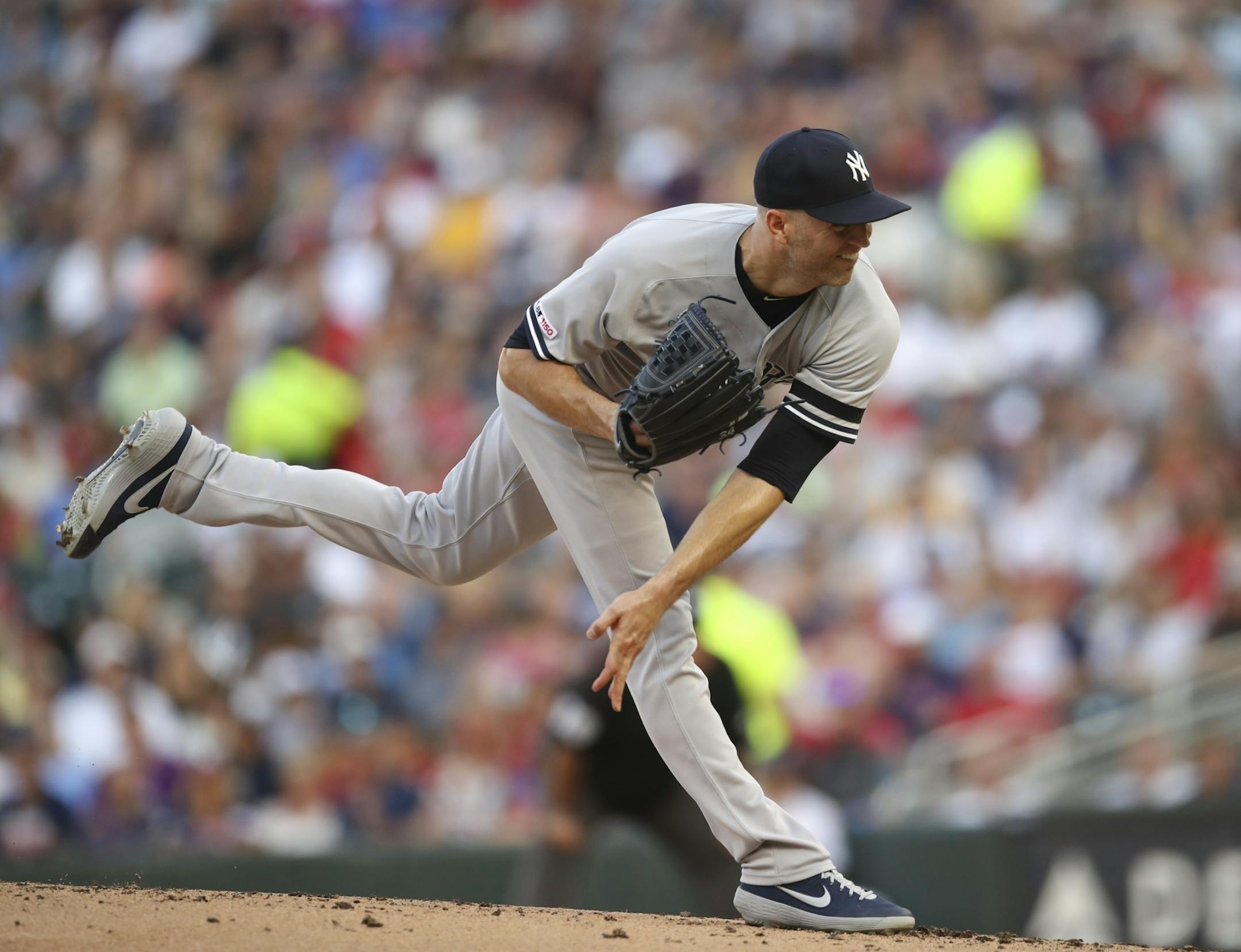 New York Yankees starting pitcher J.A. Happ throwing to the Twins in the first inning.