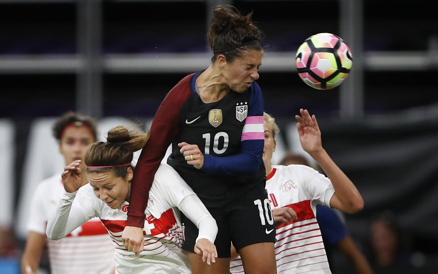 USA Carli Lloyd headed the ball away from Switzerland Vanessa Bernauer in the first half at U.S. Bank Stadium Sunday October 23, 2016 in Minneapolis, MN. ] U.S. women's national team gamer vs. Switzerland at U.S. Bank Stadium. Jerry Holt / jerry. Holt@Startribune.com