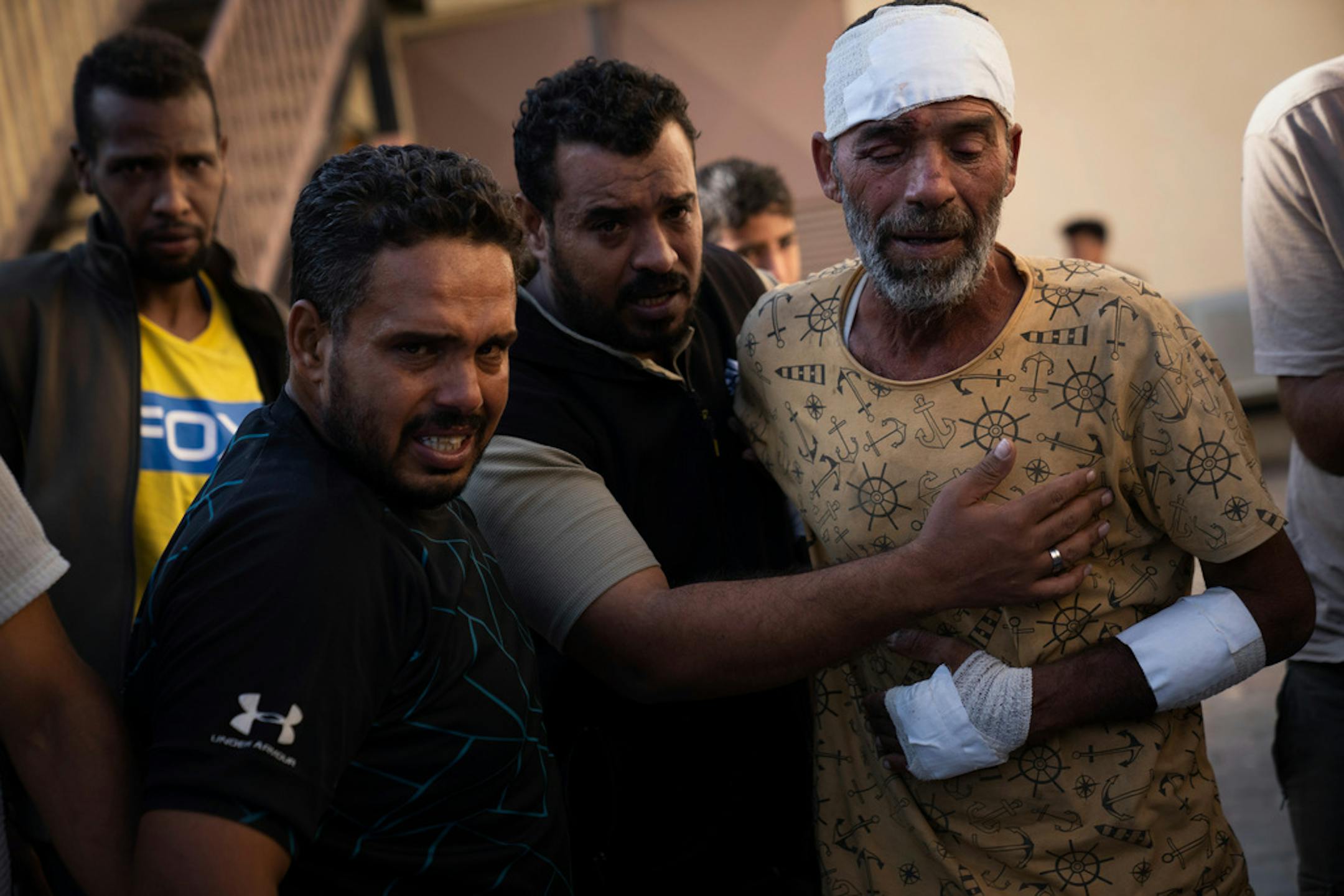 Palestinians mourn relatives killed in the Israeli bombardment of the Gaza Strip, in front of the morgue in Deir al Balah, Tuesday, Oct. 31, 2023. ( AP Photo/Fatima Shbair)