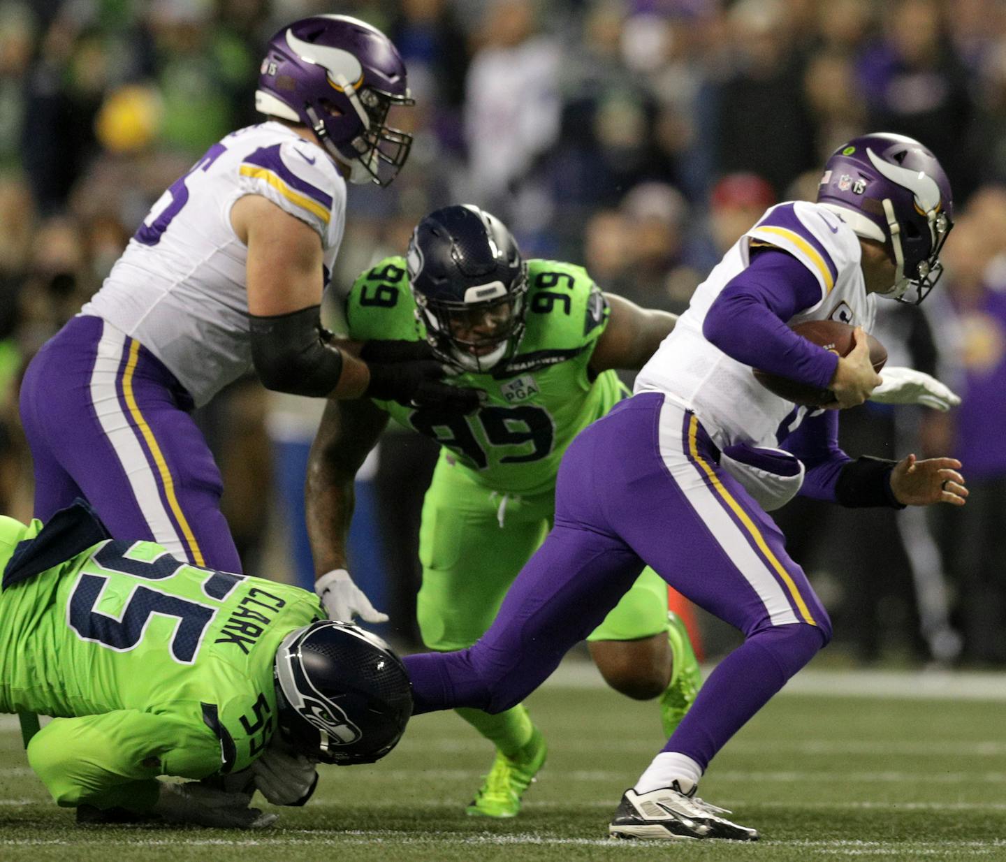 Vikings quarterback Kirk Cousins gets pulled down by Frank Clark for the sack in the 2nd quarter.