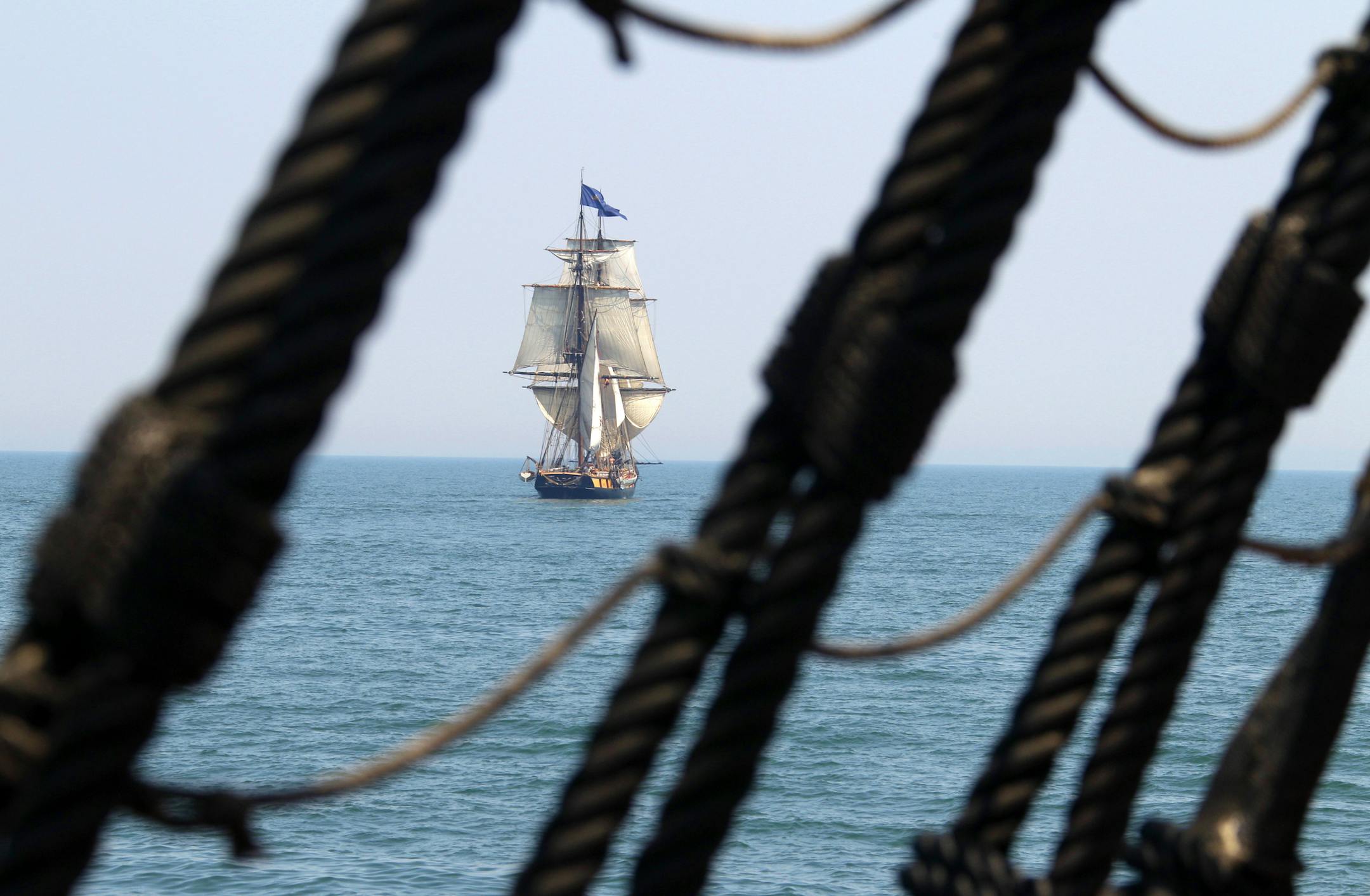 The tall ship Niagara is seen through the rigging of the HMS Bounty in Lake Erie off Cleveland in this file photo.