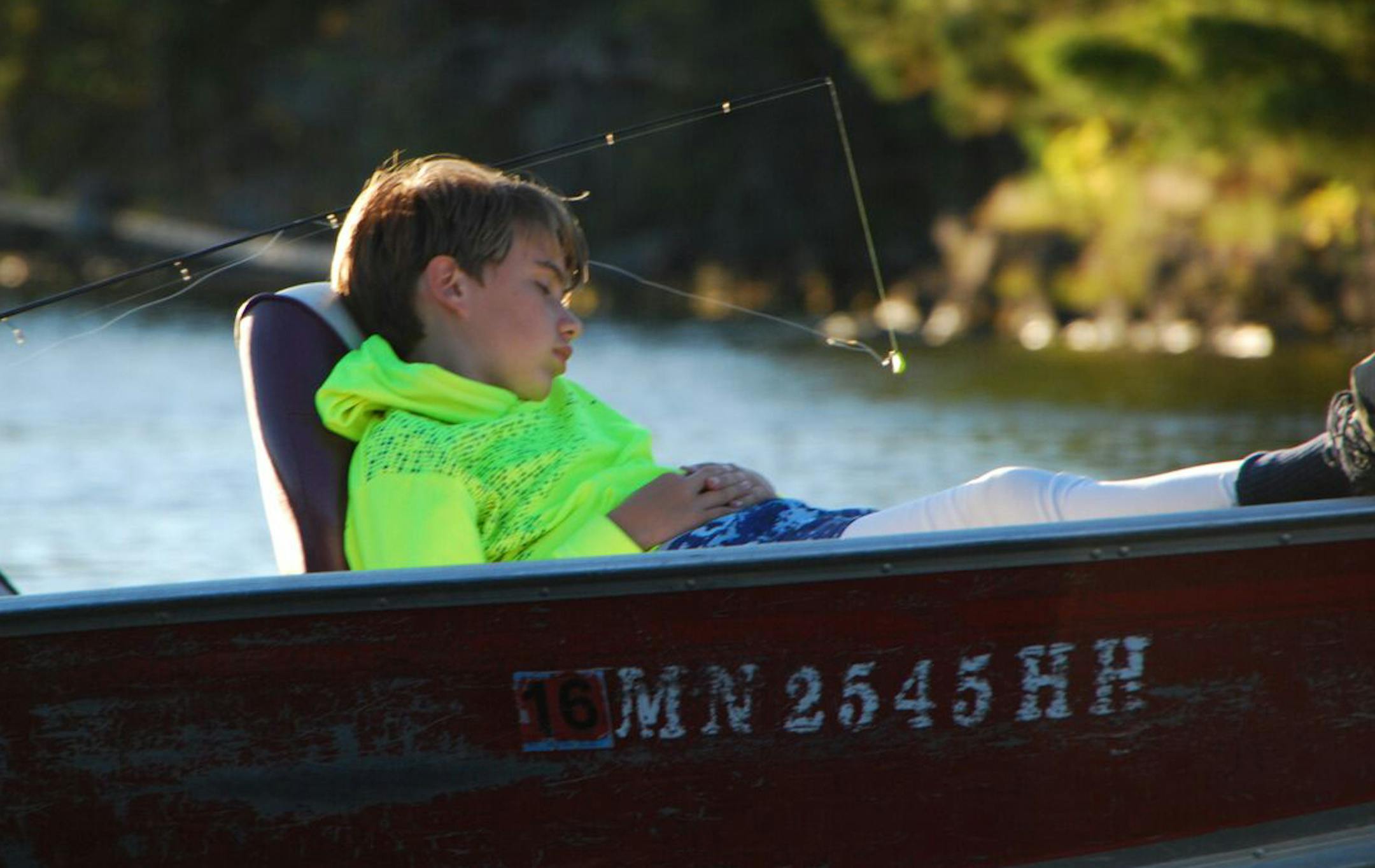 Cal Kennedy, 12, naps in the bow of his dadís boat on a slow walleye day on Sand Point Lake in Voyageurs National Park. Photo by Scott Gillespie.
