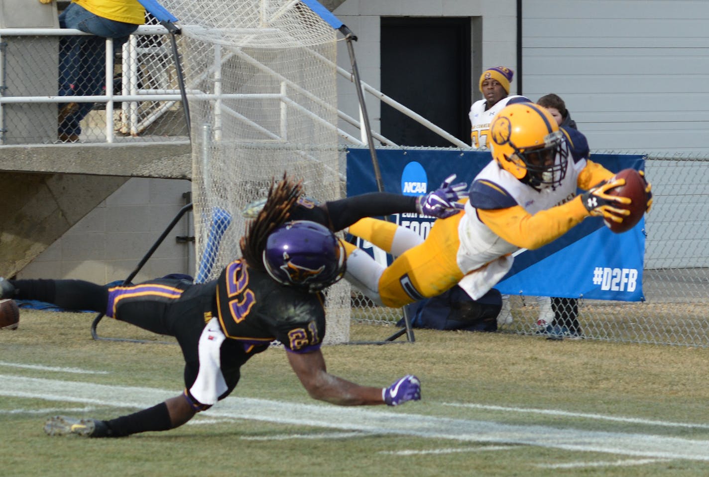 Photo credit: Josh Manck (of Texas A&M-Commerce).
Marquis Wimberly dives past MSU Mankato defender Keyshawn Davis to complete a 30-yard touchdown reception which gave the Lions a 30-21 lead with 6:47 left in the fourth quarter.