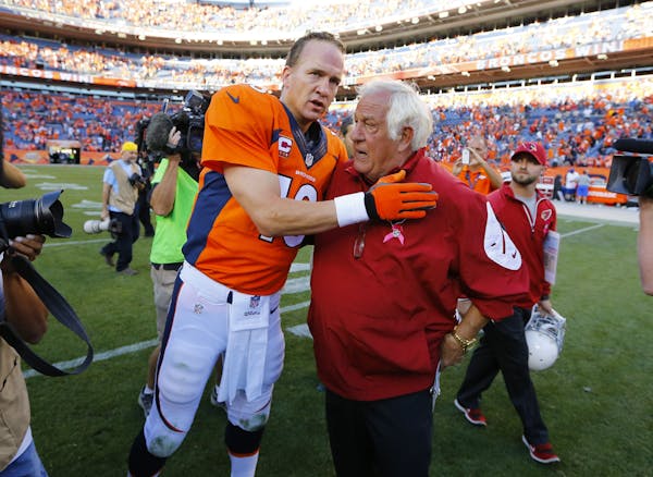 Denver Broncos quarterback Peyton Manning (18) greets Arizona Cardinals assistant head coach Tom Moore after an NFL football game against the Arizona 