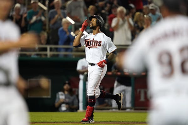 Twins center fielder Byron Buxton pointed to the sky as he rounded third base after hitting a home run during Saturday's game.
