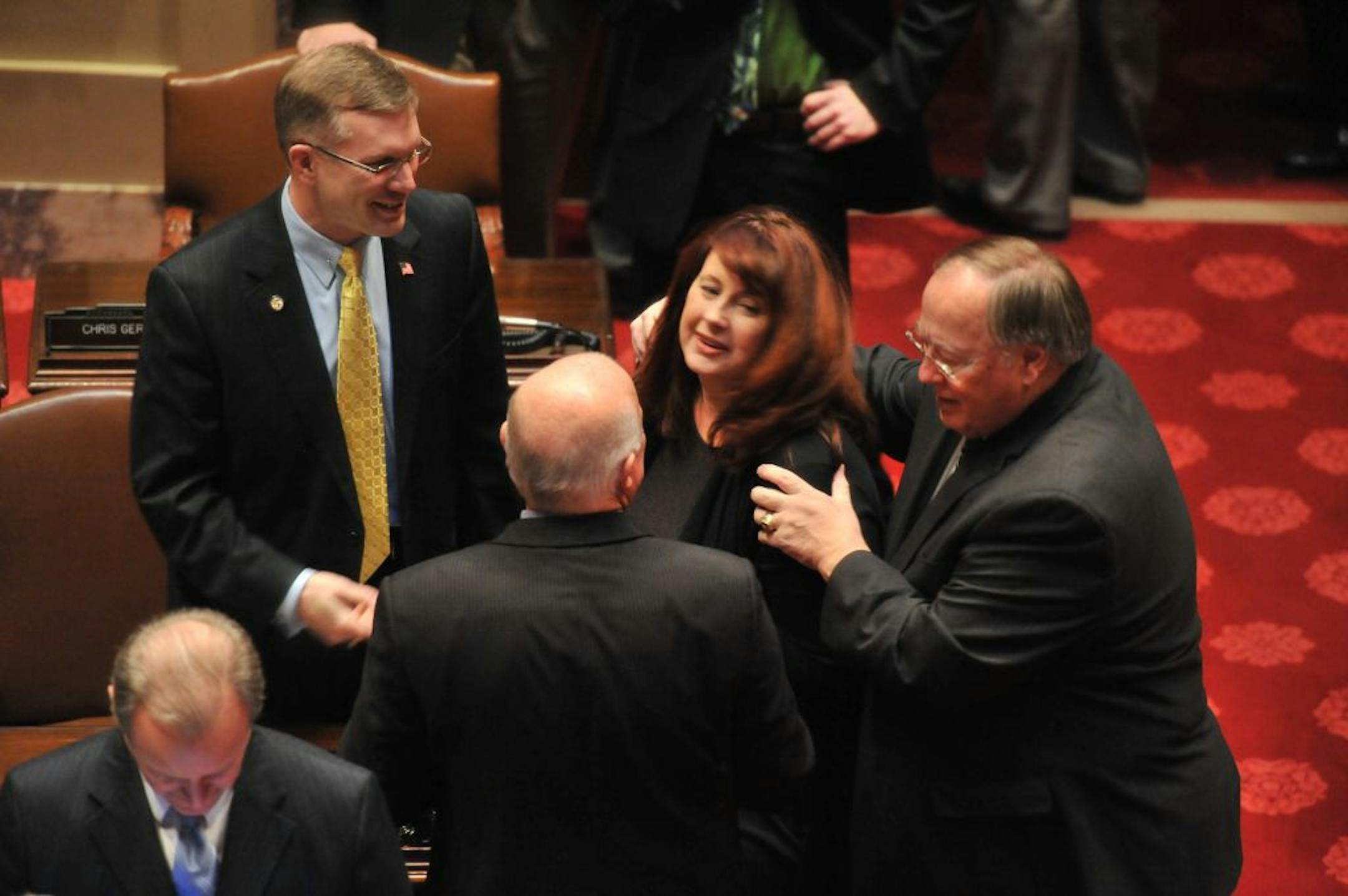 Sen. Amy Koch is greeted and hugged as she arrives on the Minnesota Senate floor Tuesday, Jan. 24, 2012, in St. Paul. Sen. David Senjem, right, is the new Senate Majority Leader in the wake of Koch's resignation.
