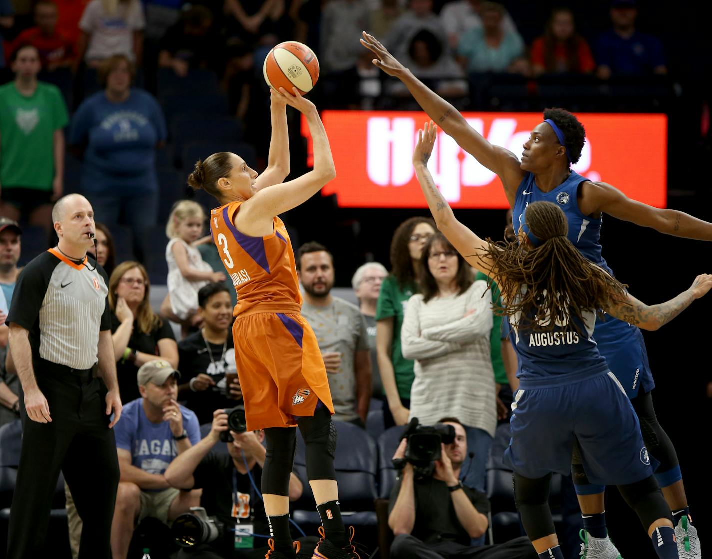 Phoenix Mercury's Diana Taurasi (3) hits a shot over Minnesota Lynx's Seimone Augustus (33) and Sylvia Fowles