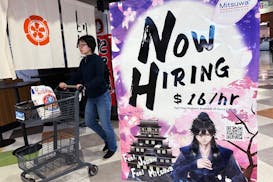 A hiring sign is displayed at a restaurant in Arlington Heights, Ill., June 28.