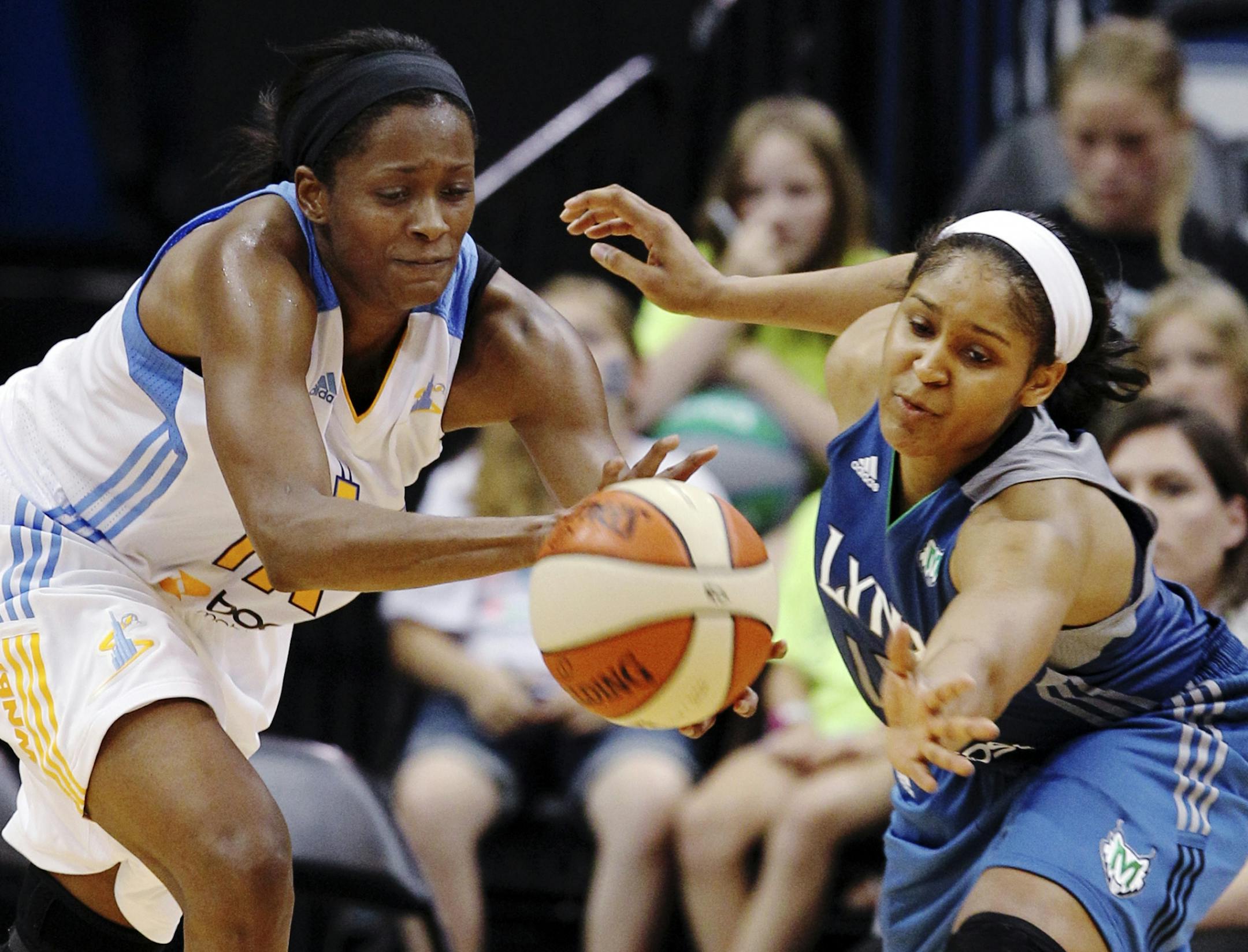 Chicago Sky forward Swin Cash, left, and Minnesota Lynx forward Maya Moore reach for a loose ball during the second half of a WNBA basketball game, Saturday June 23, 2012, in Minneapolis. The Lynx won 79-67.